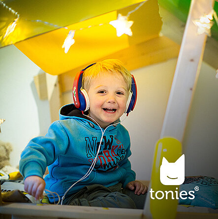 Kleiner Junge mit Kopfhörern lächelt