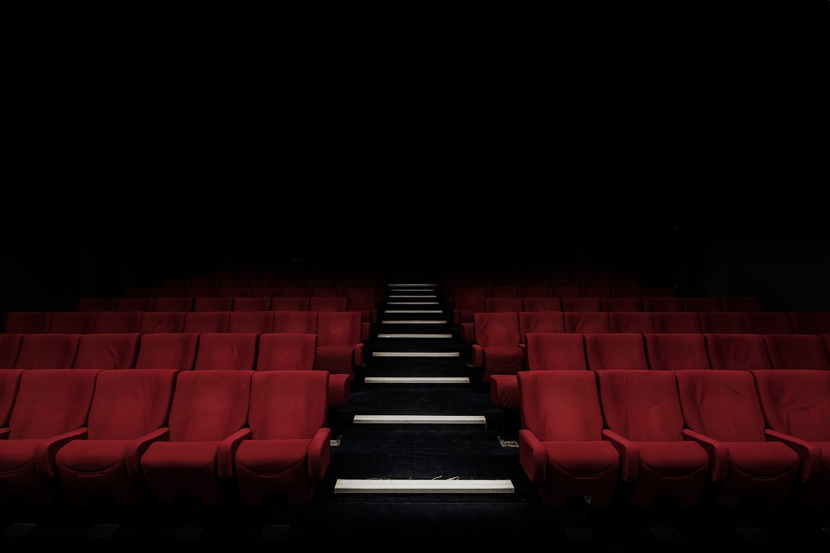 An empty cinema with dark lighting.
