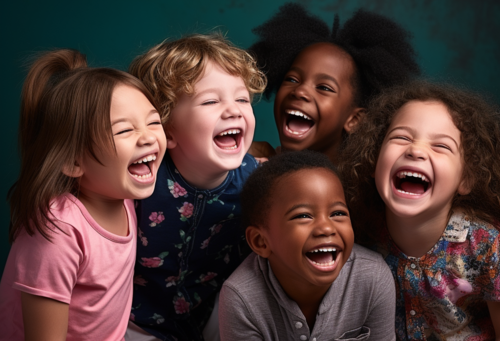 Five smiling children from different backgrounds stand close together and enjoy the moment.