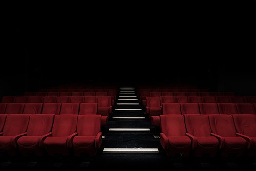 An empty cinema with dark lighting.