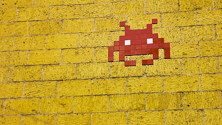 Gaming Taps Into Nostalgia A red pixel figure on a yellow background, which reminds the viewer of the nostalgia of games.