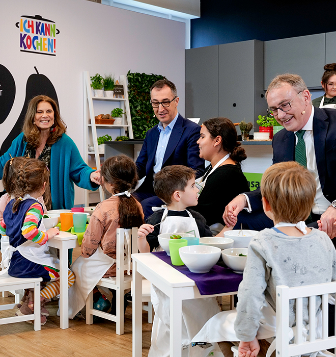 Eine Frau und ein Mann mittleren Alters sprechen mit Kindern