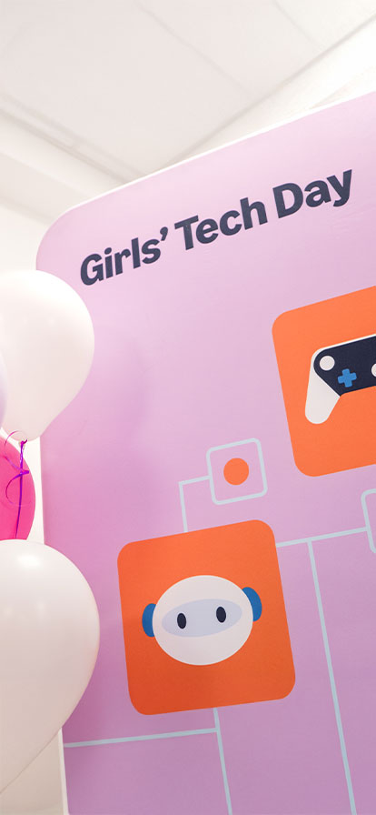 Rosa Schild mit der Beschriftung Girls Tech Day und weiße Luftballons auf der Seite