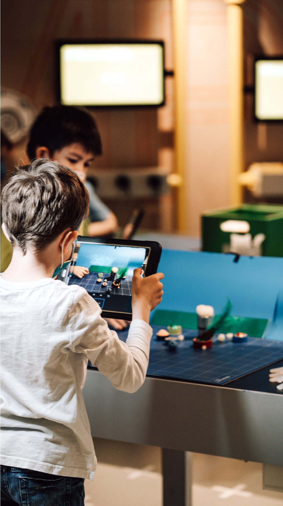 Little boy participates in a workshop.
