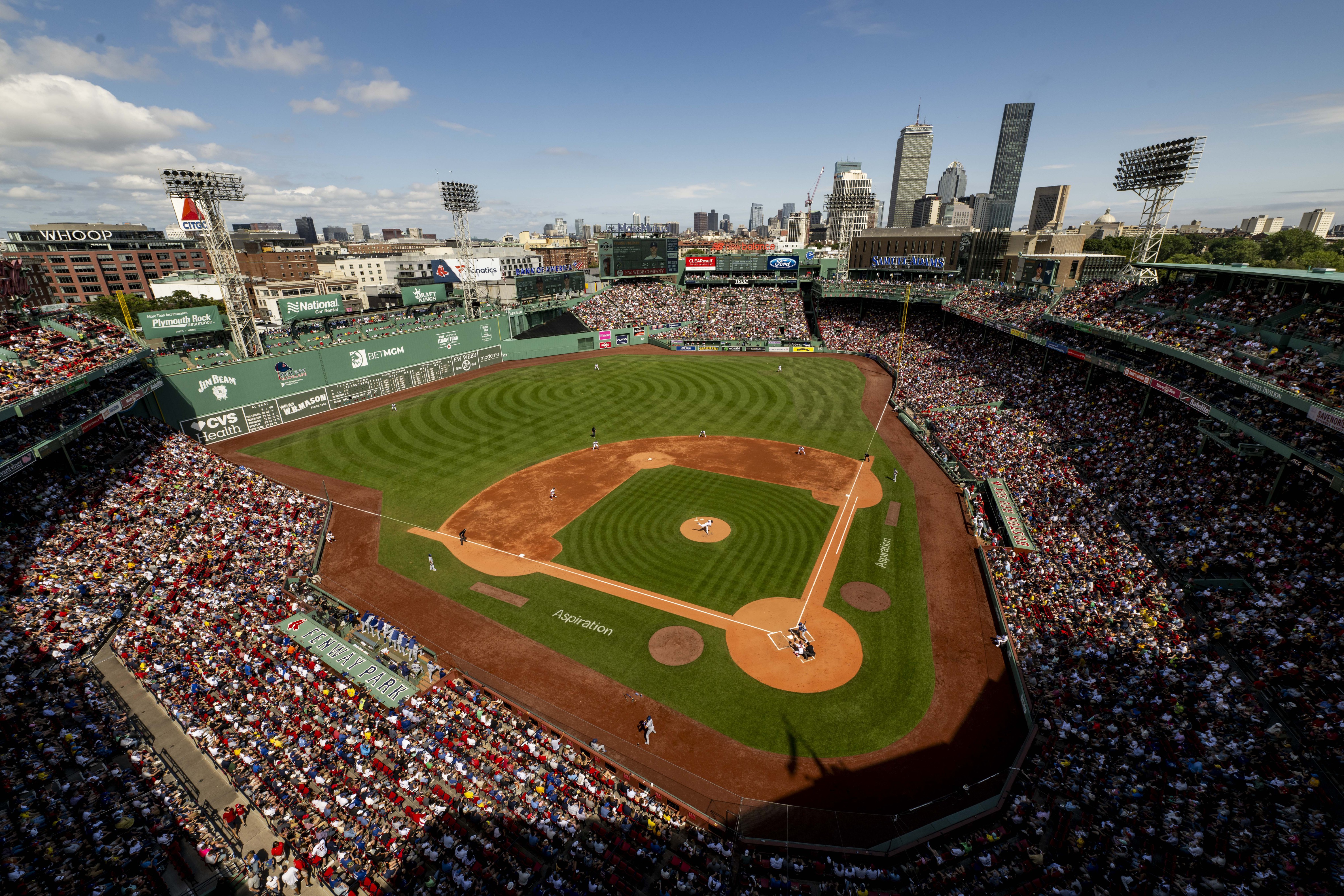 Baseball field with spectator stands and a blue, sunny sky in the background.