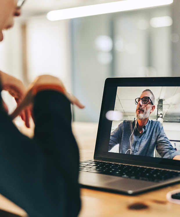  woman is in an online meeting with a man, and they are discussing a project.